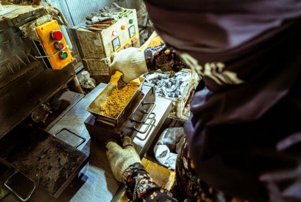 Food processing equipment and an operator at a production workstation (stock photograph).