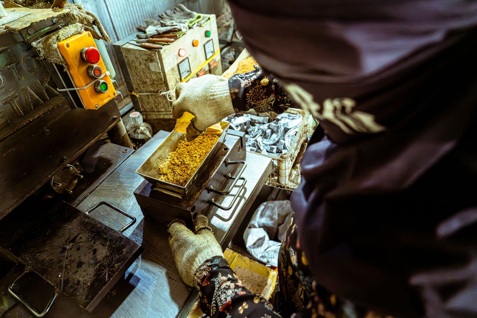 Food processing equipment and an operator at a production workstation (stock photograph).