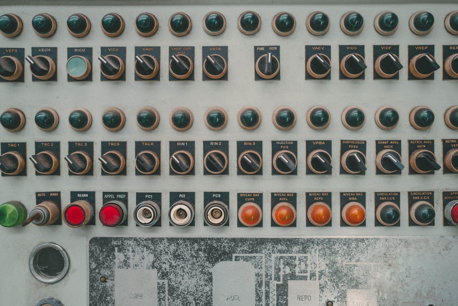 Industrial control panel with rows of buttons and selector switches (stock photograph).