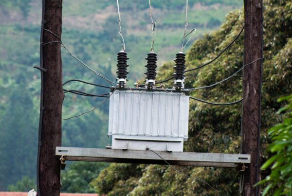 Pole-mounted electrical transformer with connected overhead wires (stock photograph).
